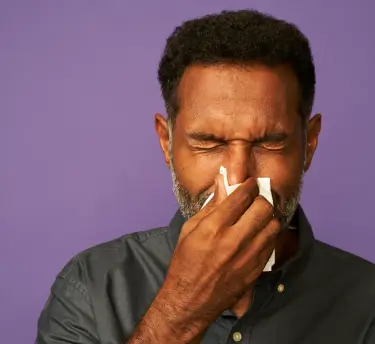 A man blowing his nose